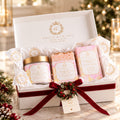 A luxury gift set from Gracie & Co. 1942, featuring a champagne-themed bath and body set in an open white gift box with a red ribbon and wreath.